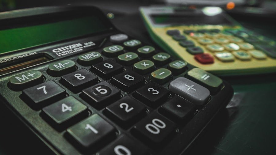 A black and green calculator sitting on a table.